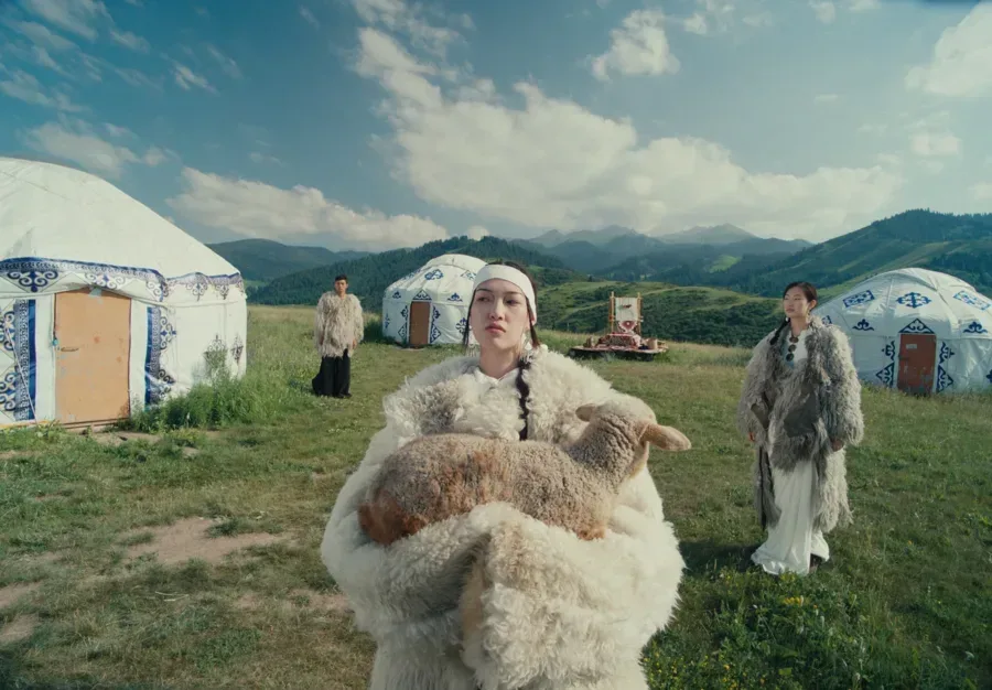 People in traditional clothing standing in a mountain landscape